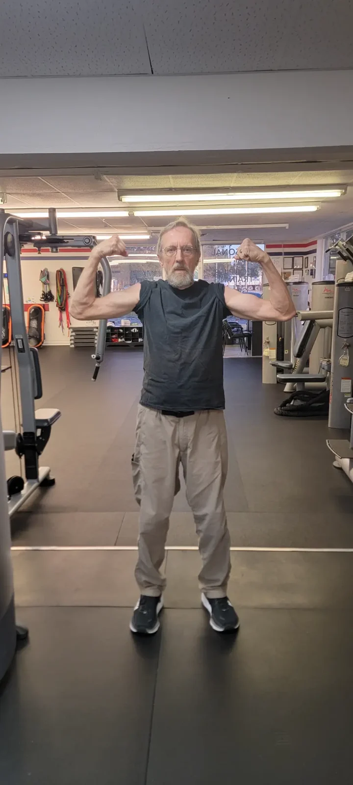 An older adult lifting weights at Freedom Fitness